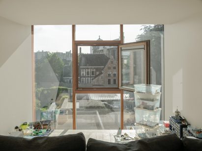 Floor to ceiling windows are wood framed