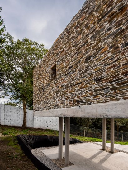 Stone-clad house on stilts