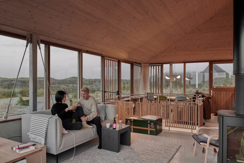 Plywood-lined living room in holiday home by Unknown Architects