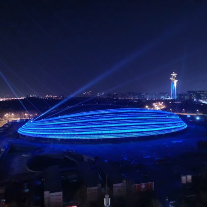 Illuminated exterior of Ice Ribbon by Populous for Beijing 2022 Winter Olympics