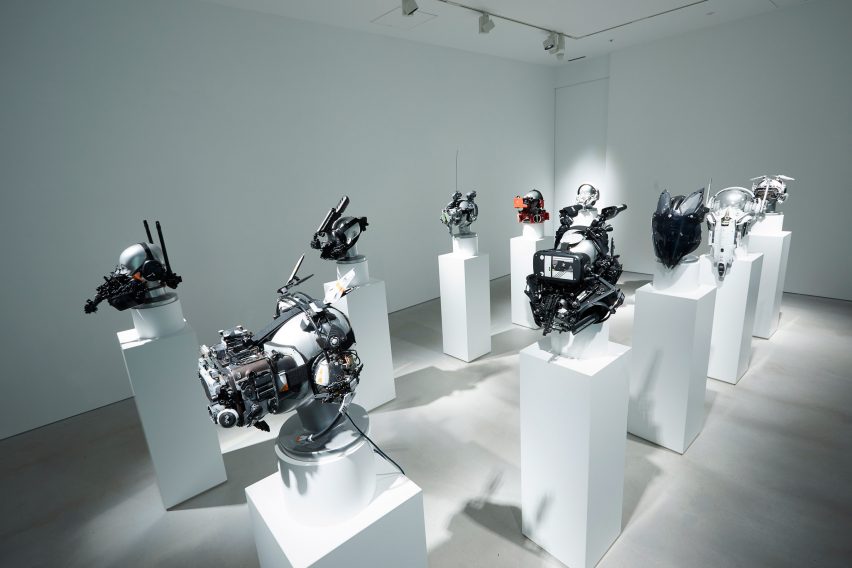 Gallery space with a series of cyberpunk masks positioned on plinths