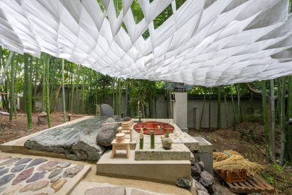 Fabric forms a fabric ceiling above a spa