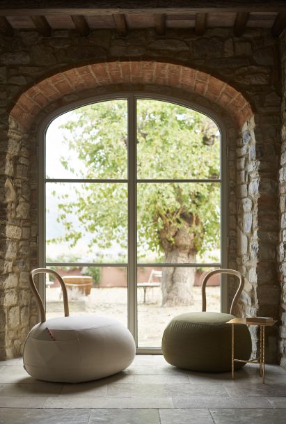 Two Yum Yum seats displayed in front of an arched window