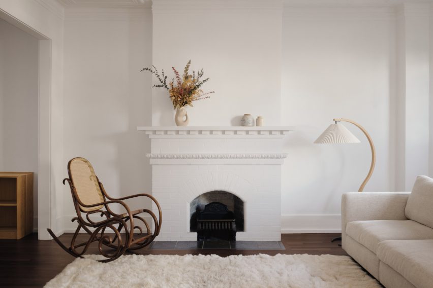 Rocking chair in front of white fireplace