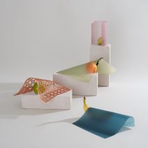 Oranges and bananas next to sheets of coloured vegan leather