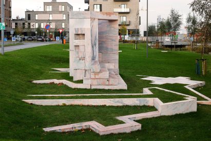 A marble sculpture and marble path on grass