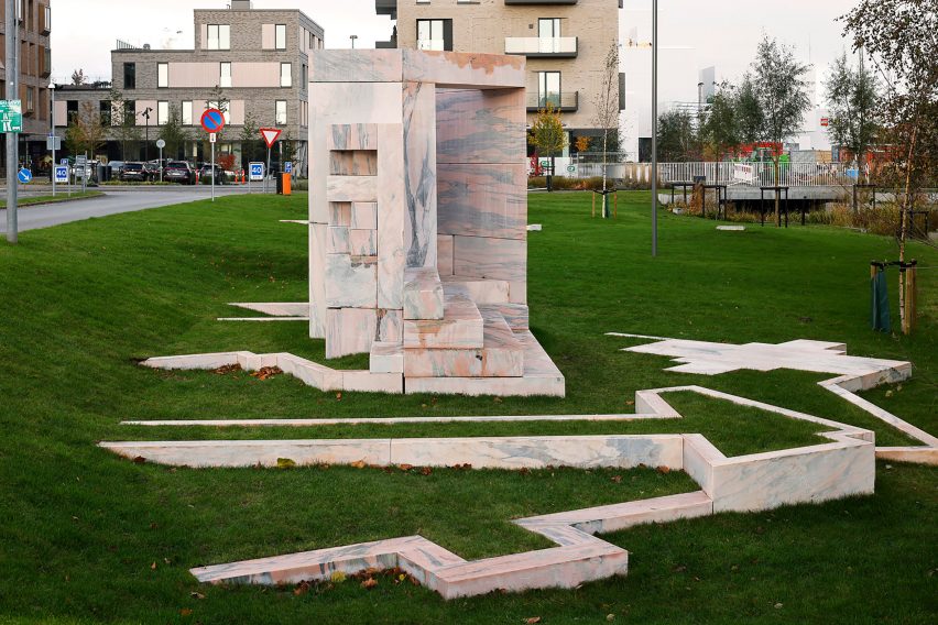 A marble sculpture and marble path on grass
