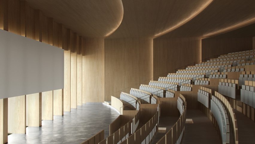 Timber lecture hall at Tilburg University with rows of curved seating looking down onto a screen lowered in front of floor-to-ceiling windows