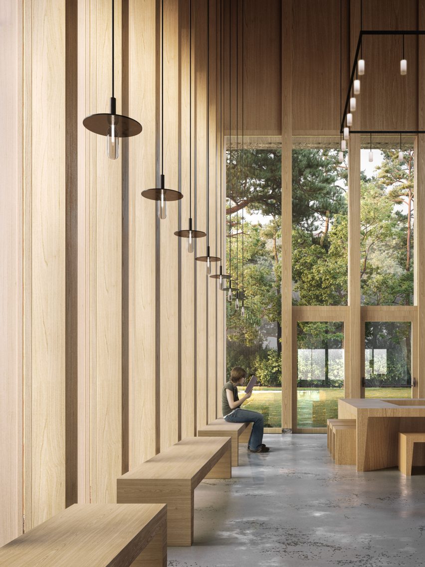 Timber foyer of the Tilburg University Lecture Hall with forest views visible through double-height windows