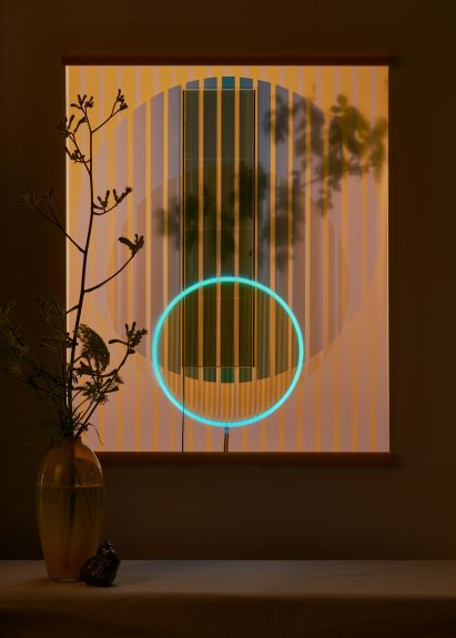 Ra tapestry pictured almost in the dark with a glowing blue ring at its centre