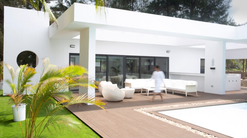 A white house and swimming pool by Tosin Oshinowo