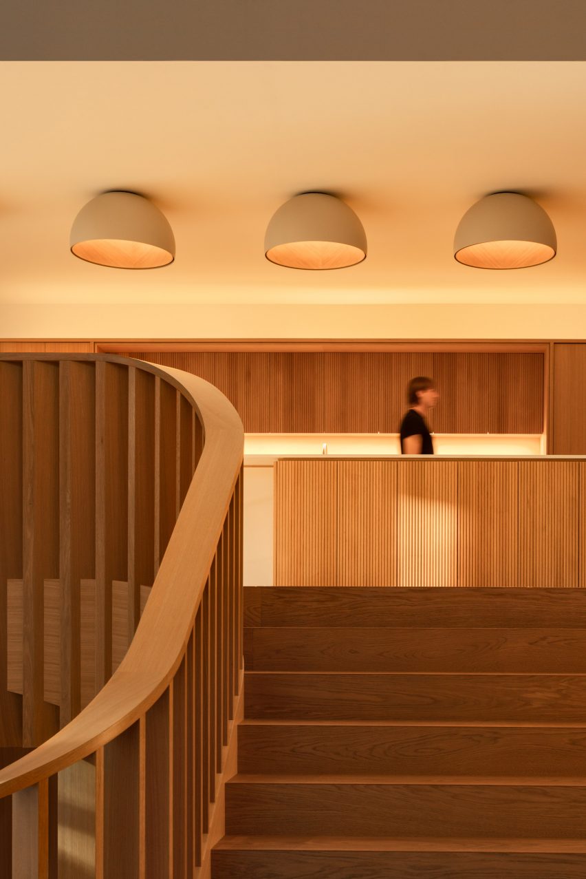 Staircase leading up to oak kitchen