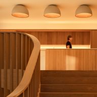Staircase leading up to oak kitchen