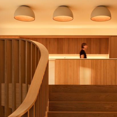 Staircase leading up to oak kitchen