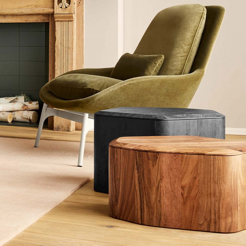A photograph of the Hoard table in black and natural colours next to a green chair