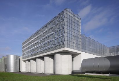 Faceted greenhouse structure sits on top of concrete silos
