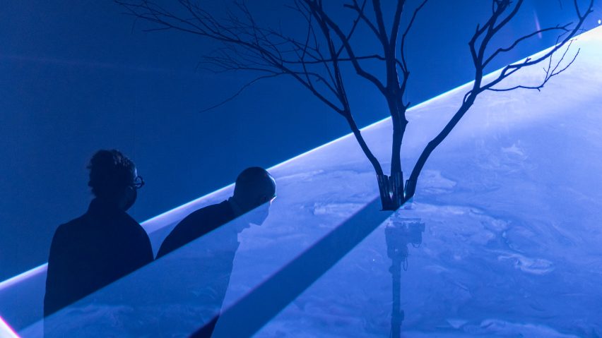 People moving through lasers at the light installation