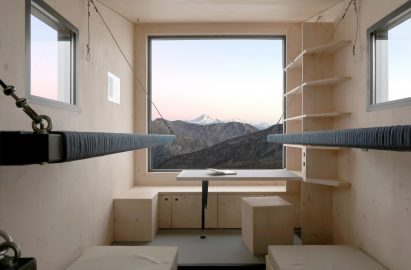 A large window provides views across the mountain range 