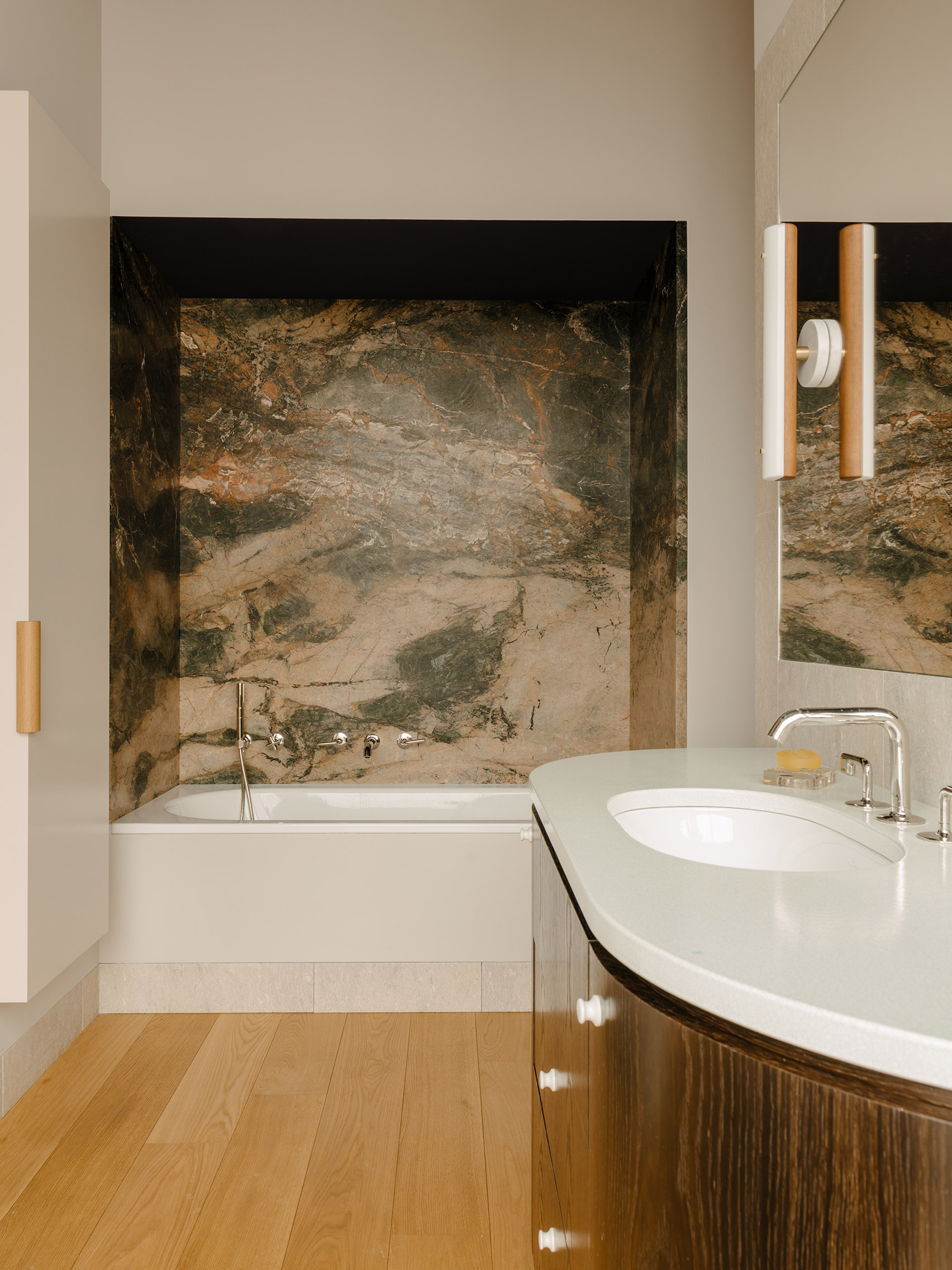 Marble wall above bath in The Village apartment by Gisbert Pöppler