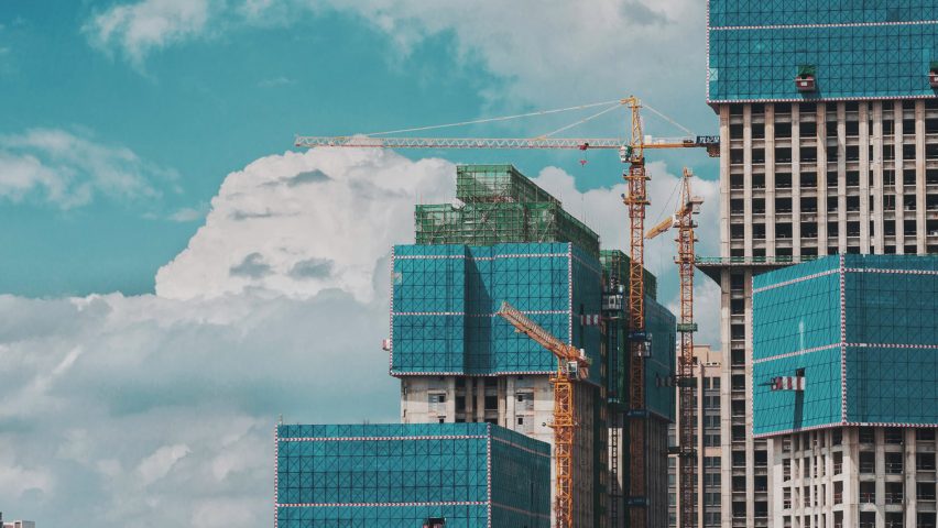 Orange crane next to buildings under construction used to illustrate stories about embodied carbon bill by Duncan Baker