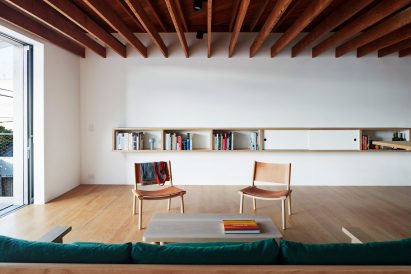 Upstairs sitting area at Emeco House by David Saik with two chairs around a coffee table and sofa