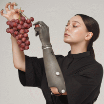 A woman wearing Esper arm and eating grapes
