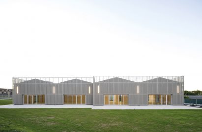 Hall wrapped in perforated metal cladding