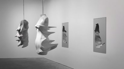 Moulds of busts from the Inertia collection are suspended from the ceiling
