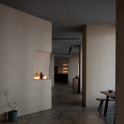 Angled beige stucco walls frame pathway through Jin Sheng Long restaurant in Qinhuangdao designed by Studio Nor