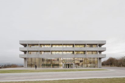 Photograph showing neutral coloured building in front of grey sky