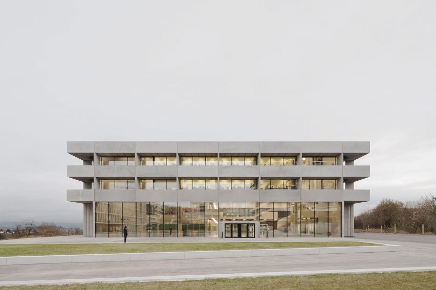 Photograph showing neutral coloured building in front of grey sky