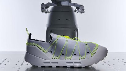 A render of a trainer with fluorescent green lacing and stitches