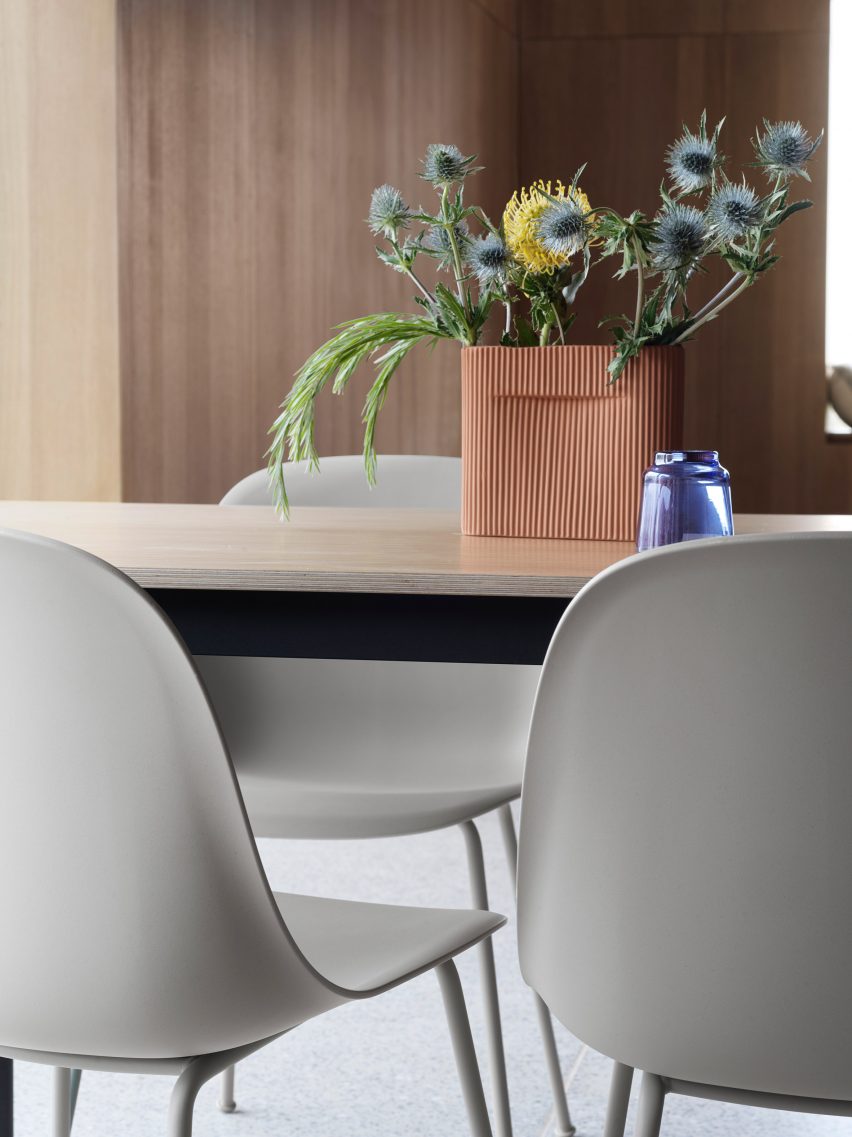 A photograph of grey office chairs around a table