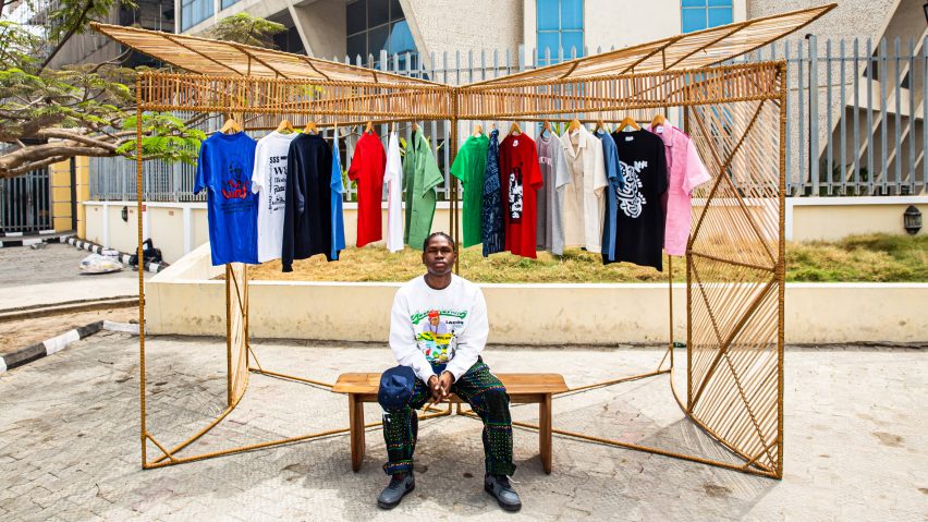 A model sitting in front of a bamboo kiosk