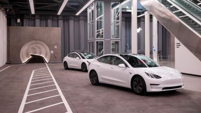 Entrance to The Boring Company's LVCC Loop system with white Teslas in front, used to illustrate a story about the North Miami Beach Loop