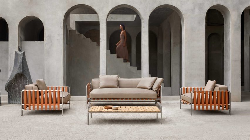 Onsen sofa and two chairs by Gandia Blasco placed outside in front of a concrete building with archways