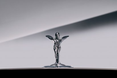 A silver female figurine with a flowing dress