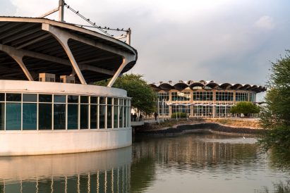 Image of the buildings at Sanand Factory next to a lake