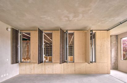 Apartment with pinewood wall with open vents to create a draft