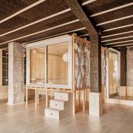 Bedroom in a wooden box raised on stilts in a cork-clad apartment by Takk