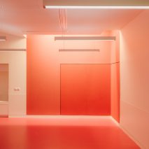 Red-painted workshop inside The Studio at the Louvre museum designed by h2o Architectes