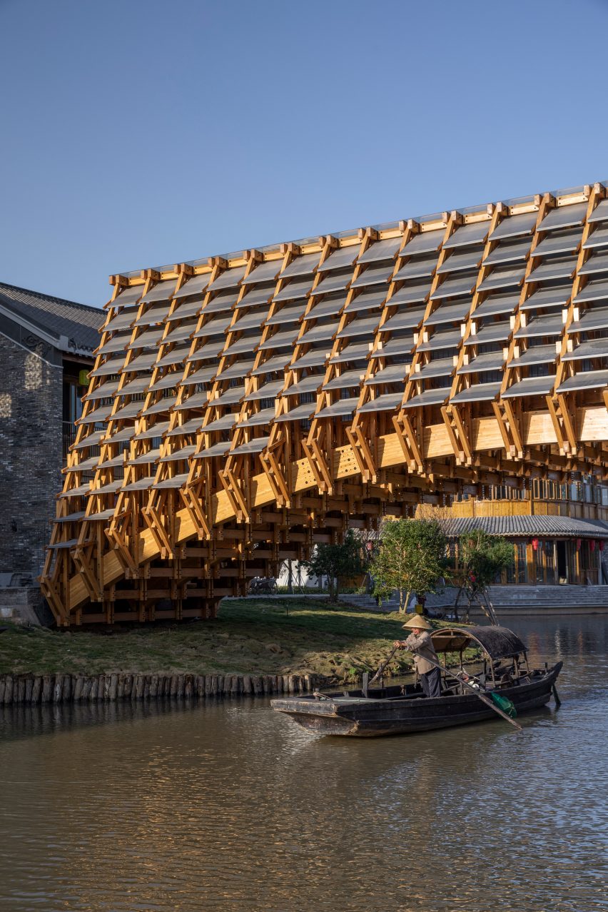 Boat passing under Timber Bridge in Gulou Waterfront, the latest project by LUO Studio