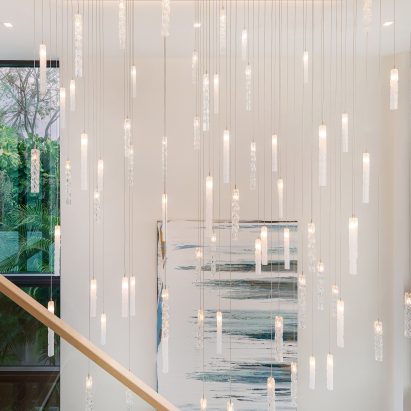 A constellation of Twist pendant lights by Dedar hung in a staircase