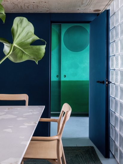 Dark-blue office with glass-brick wall