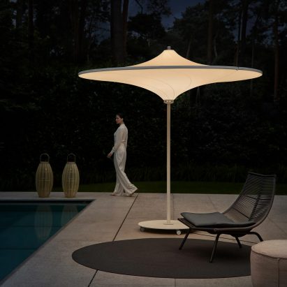 Hulasol umbrella by Hulasol at night lit up by a poolside