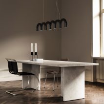 Arch pendant by Oblure in black over an office desk