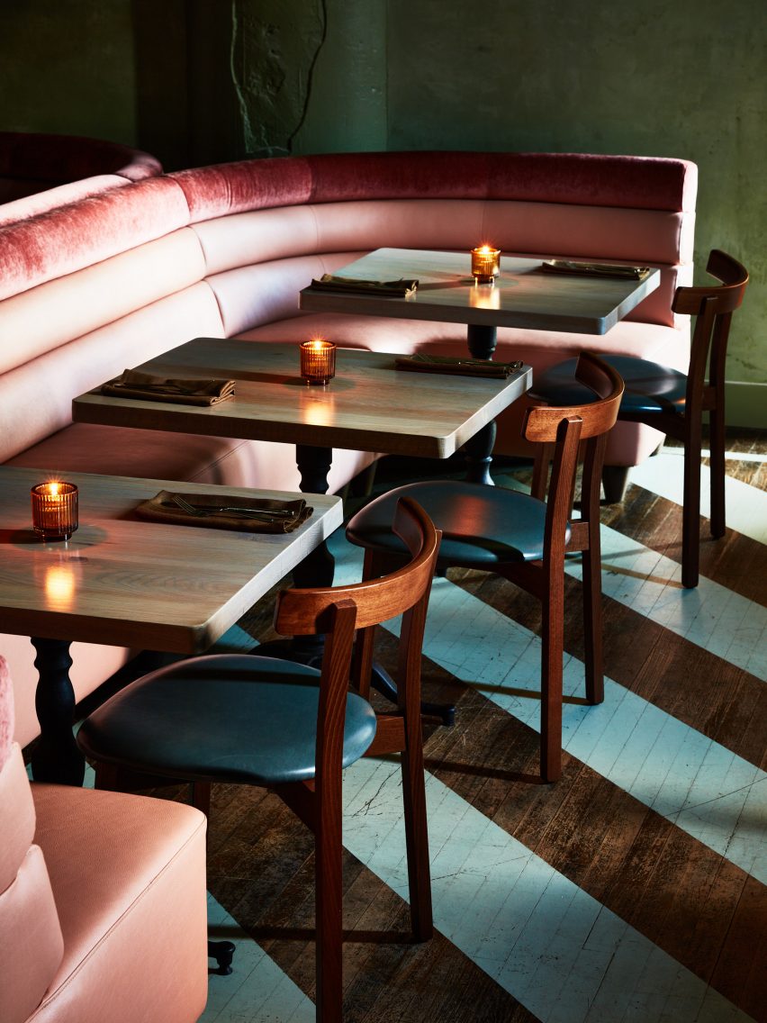 Pink banquettes and striped wooden floors