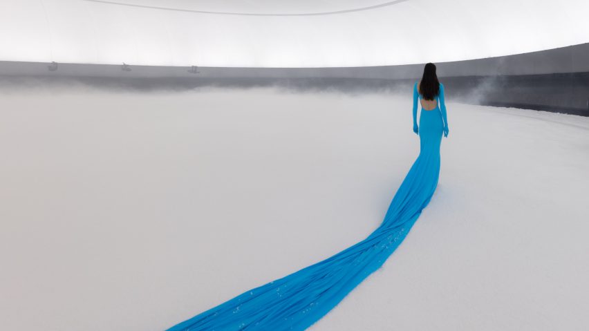 A blue dress stretches across the snowy floor