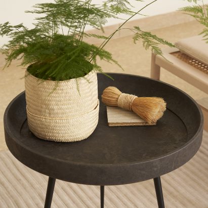 Bowl table by Ayush Kasliwal for Mater made with waste coffee shells, holding a plant and twine