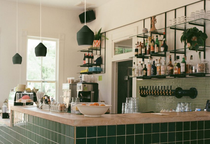 Three green Hoxton pendants by Innermost used over a green tiled bar